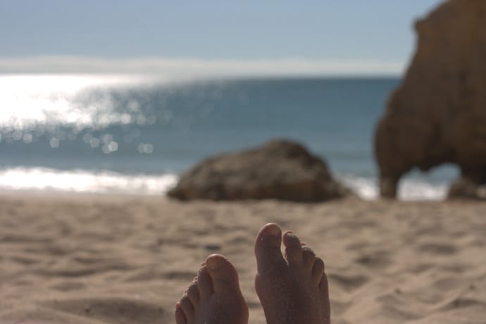 sandy feet on a sunny beach in portugal. copyright leonie wise