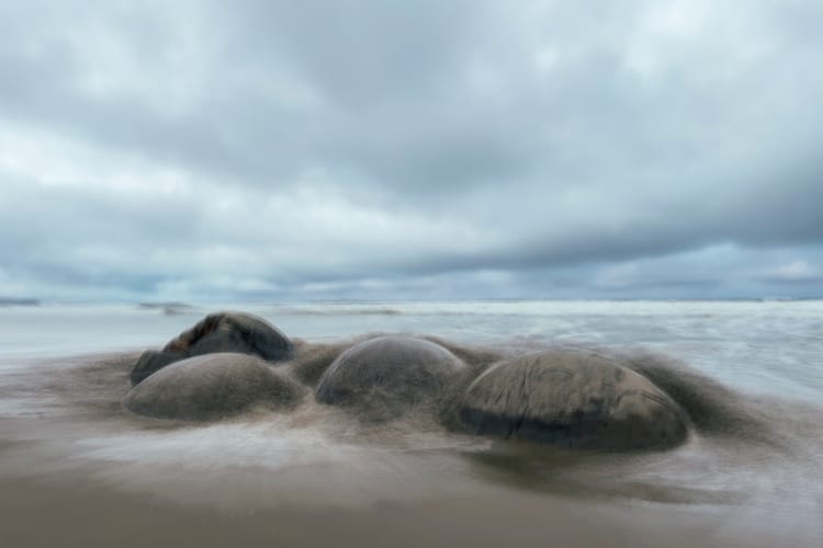 Boulders at Moeraki Beach in Southland, New Zealand, photographed with intentional camera movement © Leonie Wise