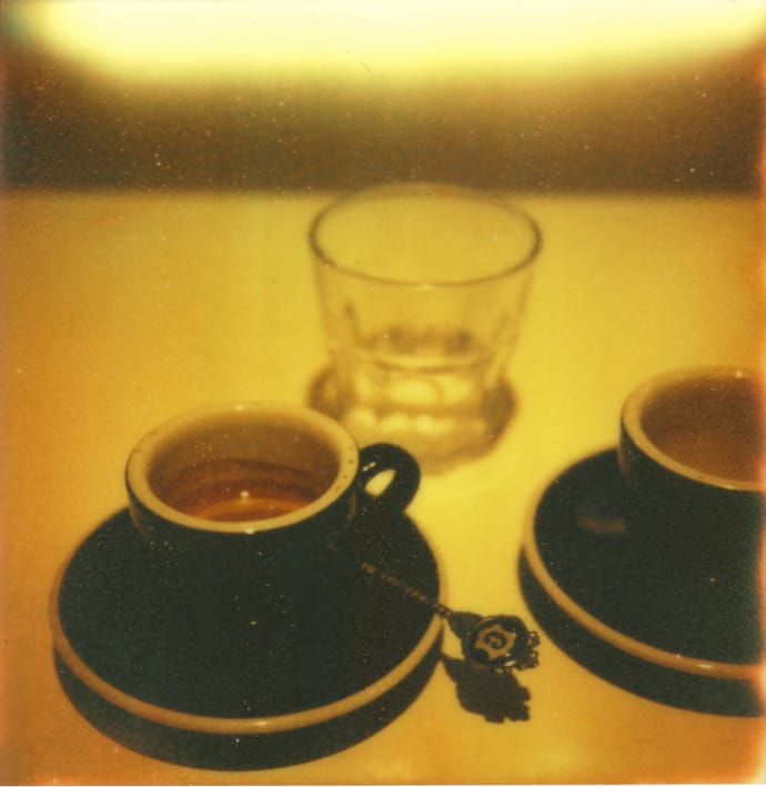 polaroid photo of two espresso cups and a water glass. copyright leonie wise