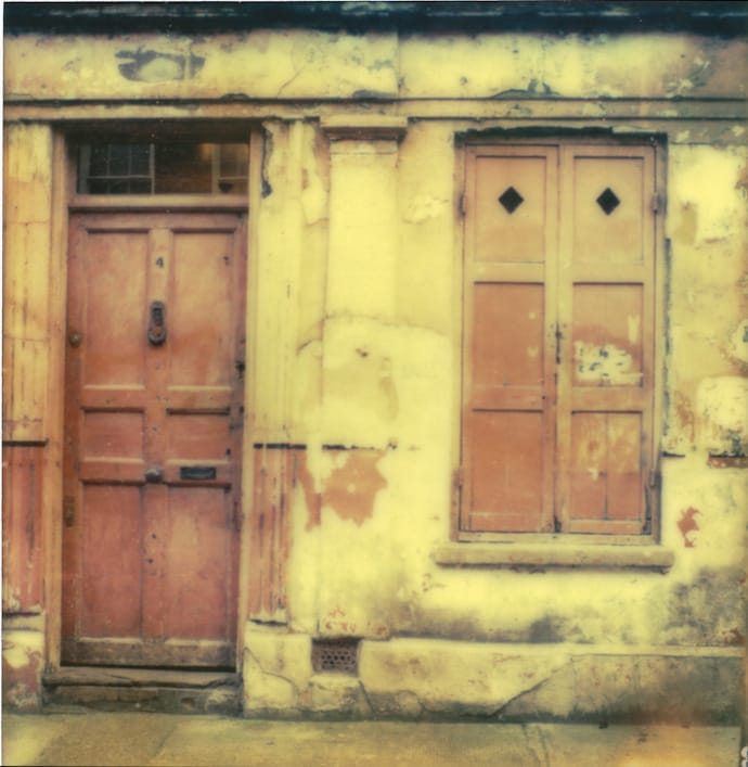 polaroid of a pink door and shutter. copyright leonie wise