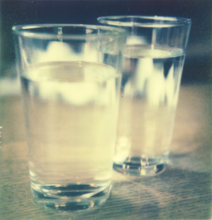 polaroid photograph of two glasses of water. copyright leonie wise