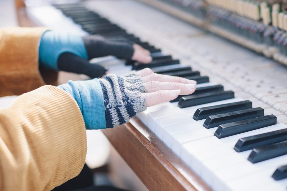 hands playing the piano. by leonie wise